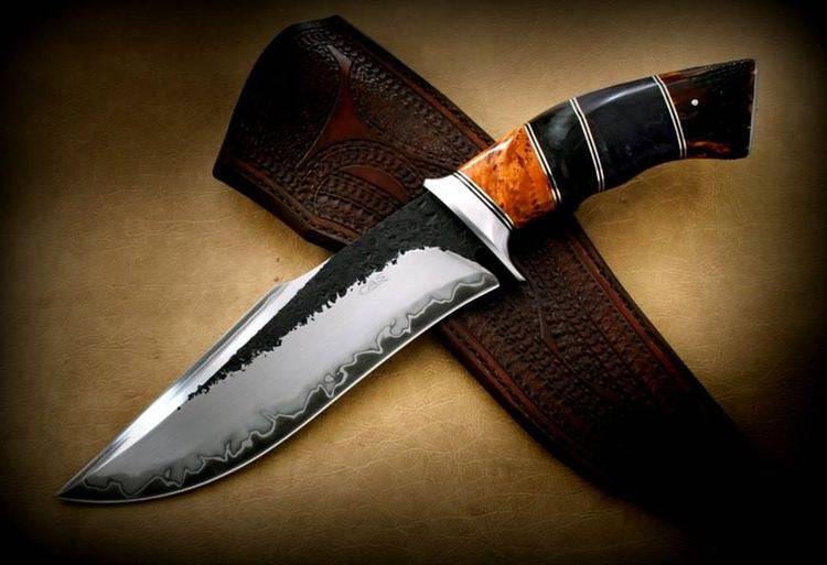 Handmade D2 steel hunting knife with custom wooden handle from Knives Gear Garage, showcasing its sharp blade and craftsmanship.