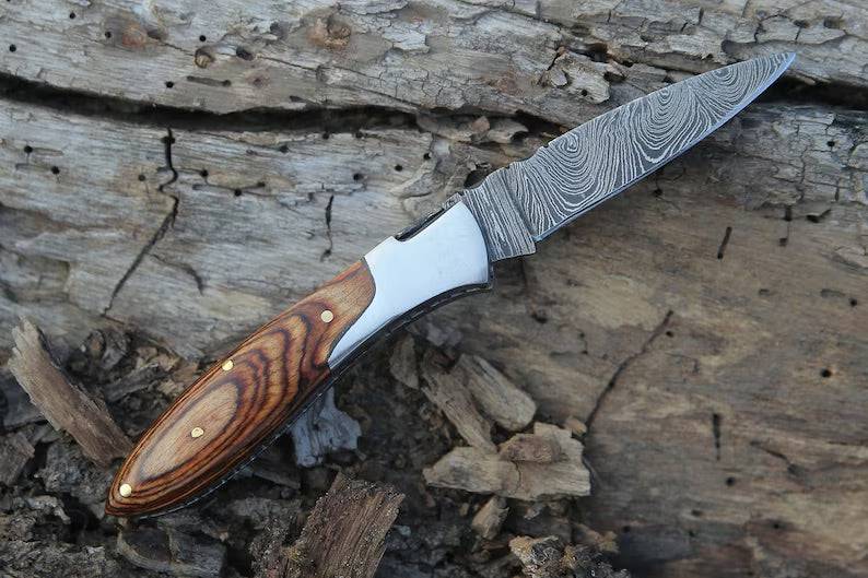 Handmade Damascus pocket knife with brown Pakka wood handle, folding design, by Knives Gear Garage.