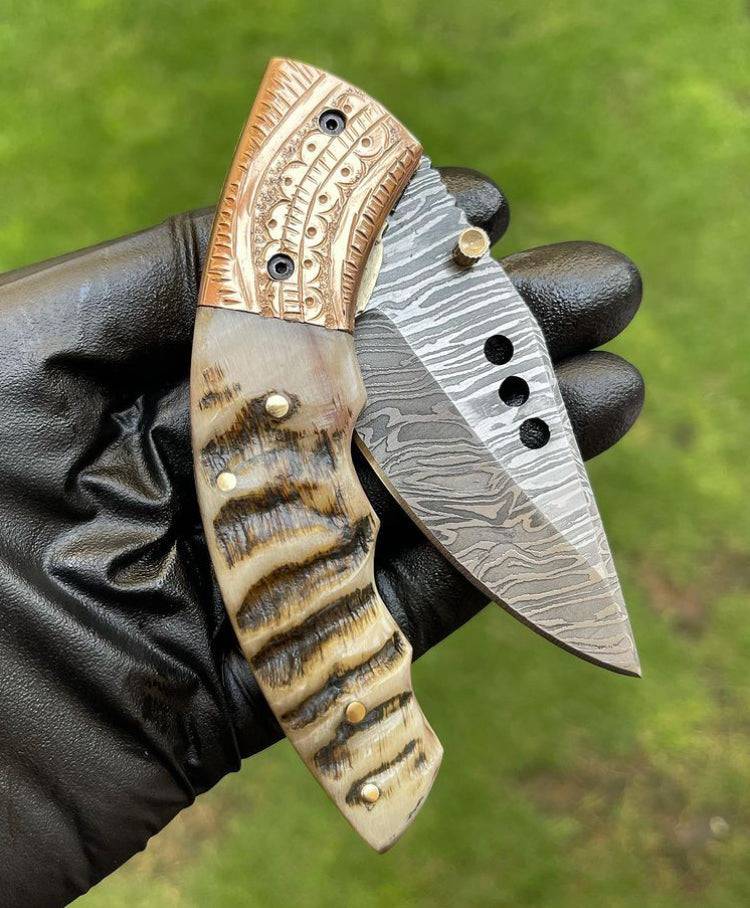 Damascus folding pocket knife by cskforged, featuring a sleek folding blade and durable handle for everyday carry.
