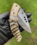 Damascus folding pocket knife by cskforged, featuring a sleek folding blade and durable handle for everyday carry.
