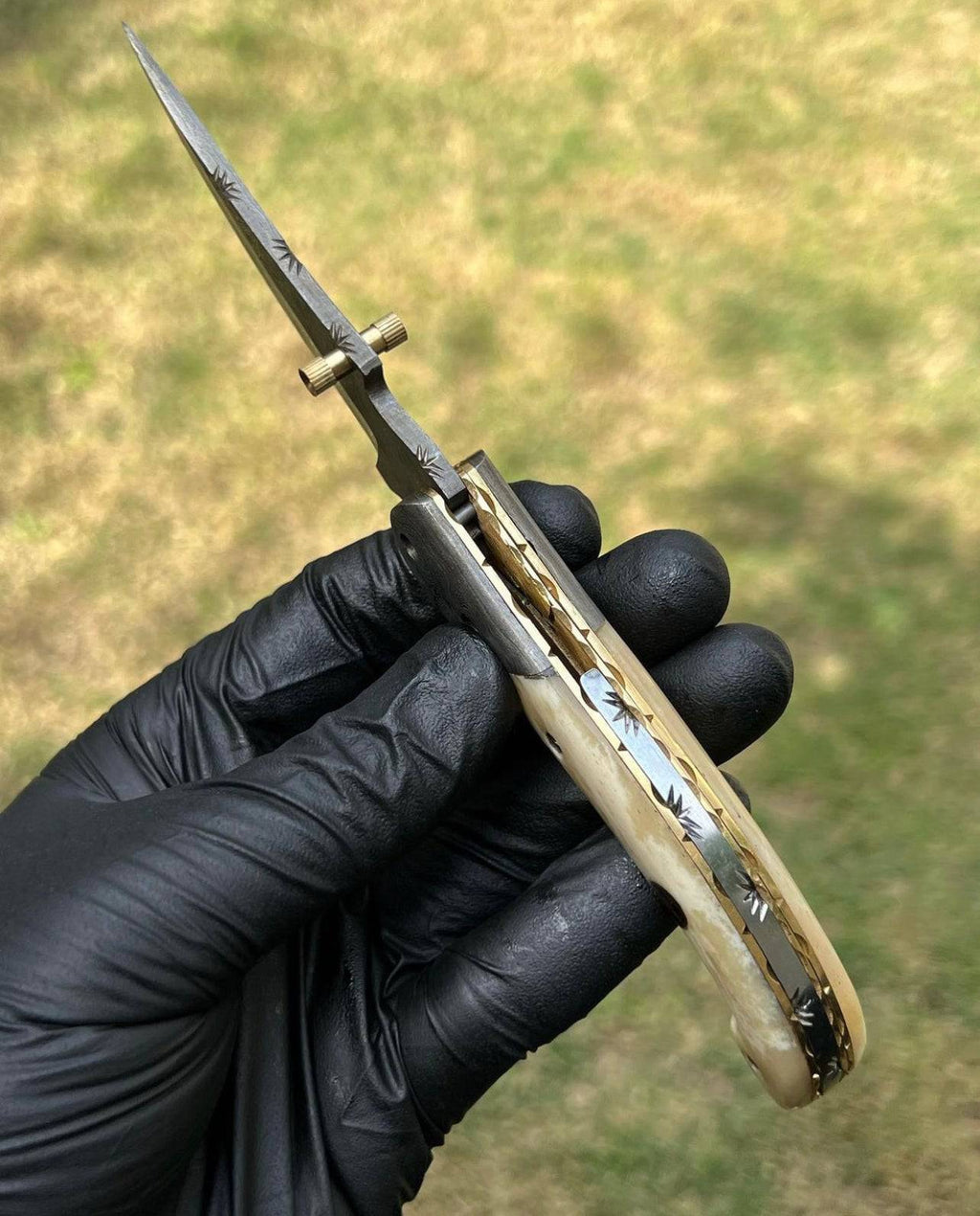 Damascus Blade EDC folding pocket knife by cskforged with a textured Damascus steel handle and a sharp folding blade.