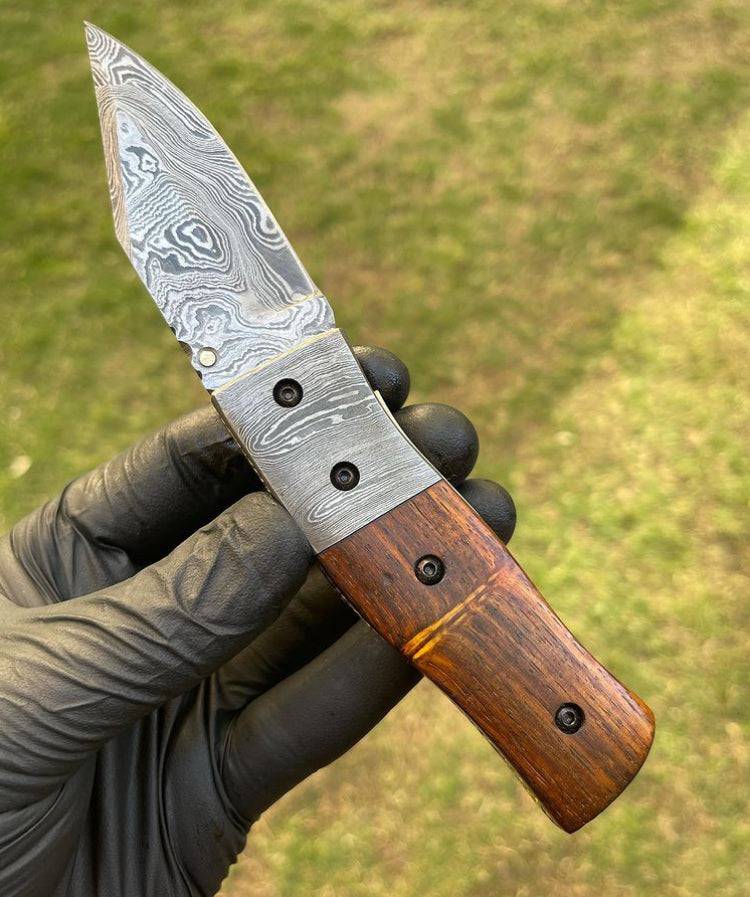 Damascus folding EDC pocket knife by cskforged, showcasing a detailed Damascus steel blade and compact folding design.