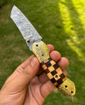 Custom handmade Damascus steel Tanto blade folding pocket knife by cskforged, featuring a sharp, intricate blade and ergonomic handle.