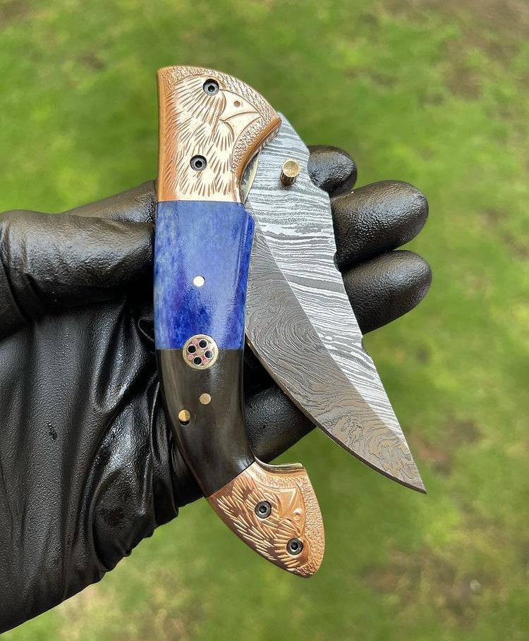 Damascus Blade EDC folding pocket knife by cskforged showing the intricate Damascus steel blade and black handle.