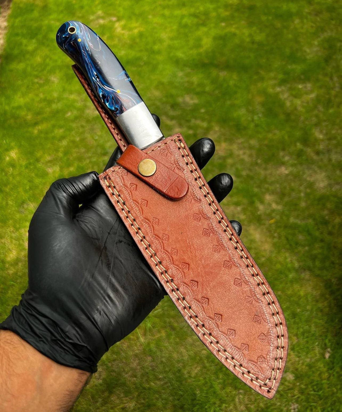 Hand forged Damascus steel chef knife by cskforged with a fixed blade, featuring a sharp, patterned blade and ergonomic handle.