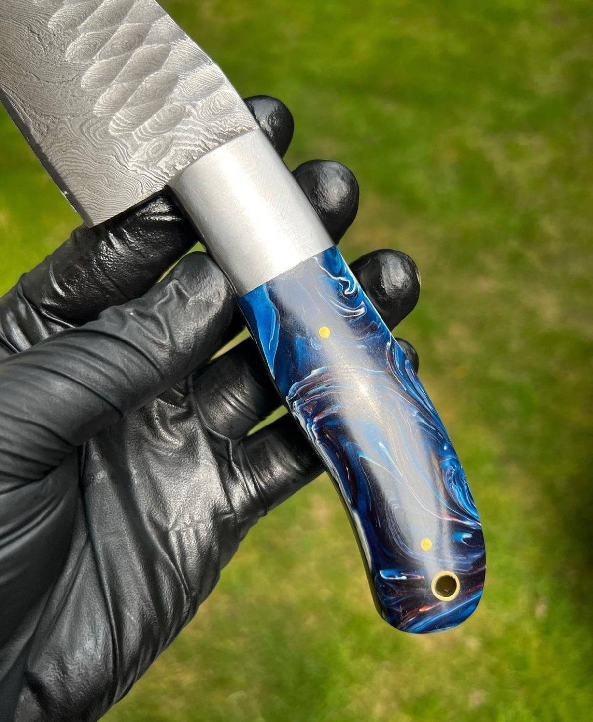 Hand forged Damascus steel chef knife by cskforged with a sharp, durable fixed blade and intricate patterning in the steel.