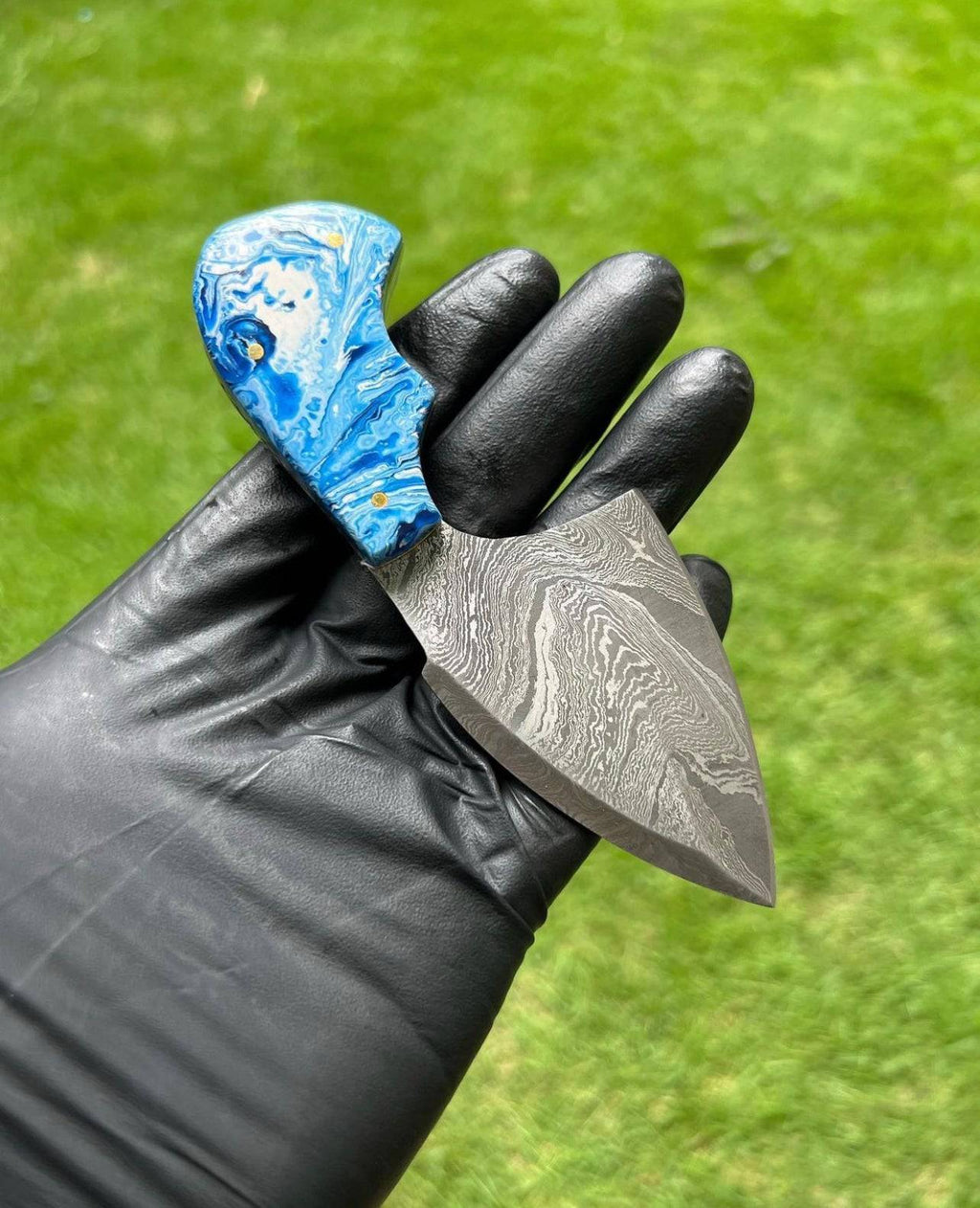 Custom handmade Damascus steel skinning knife by cskforged, featuring a sharp fixed blade with a textured handle for outdoor use.