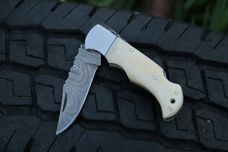 Custom handmade Knives Gear Garage folding pocket knife with 7-inch Damascus steel blade and camel bone handle.