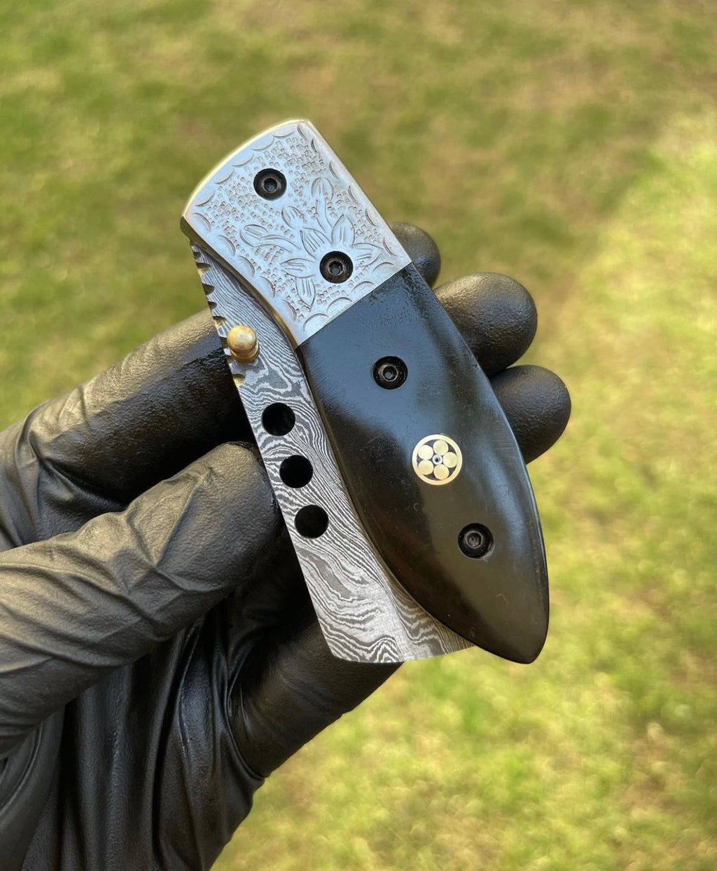 Damascus pocket folding knife by cskforged with intricate blade pattern and ergonomic handle, suitable for everyday carry and outdoor use.