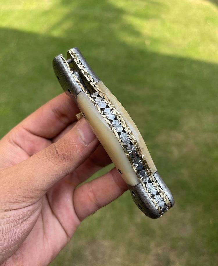 Damascus folding pocket knife by cskforged, featuring a sleek, textured blade and ergonomic handle for everyday carry.