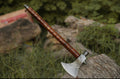 Damascus hunting axe with rosewood handle and leather sheath, featuring intricate blade design from Knives Gear Garage.