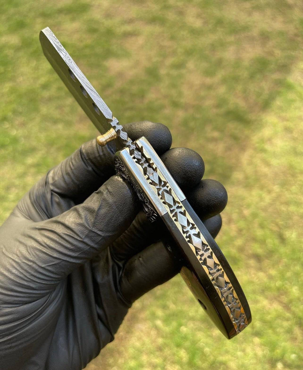 Damascus pocket folding knife by cskforged with intricate layered blade and ergonomic handle, suitable for everyday carry and outdoor use.