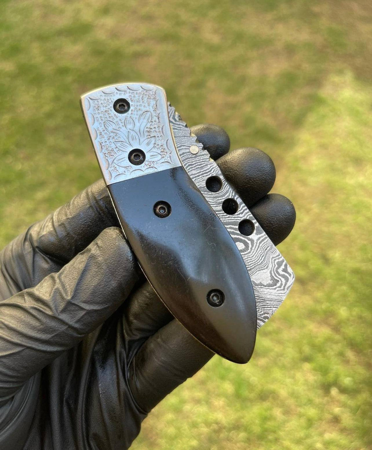 Damascus pocket folding knife by cskforged, featuring a patterned blade and ergonomic handle, displayed in a closed position.