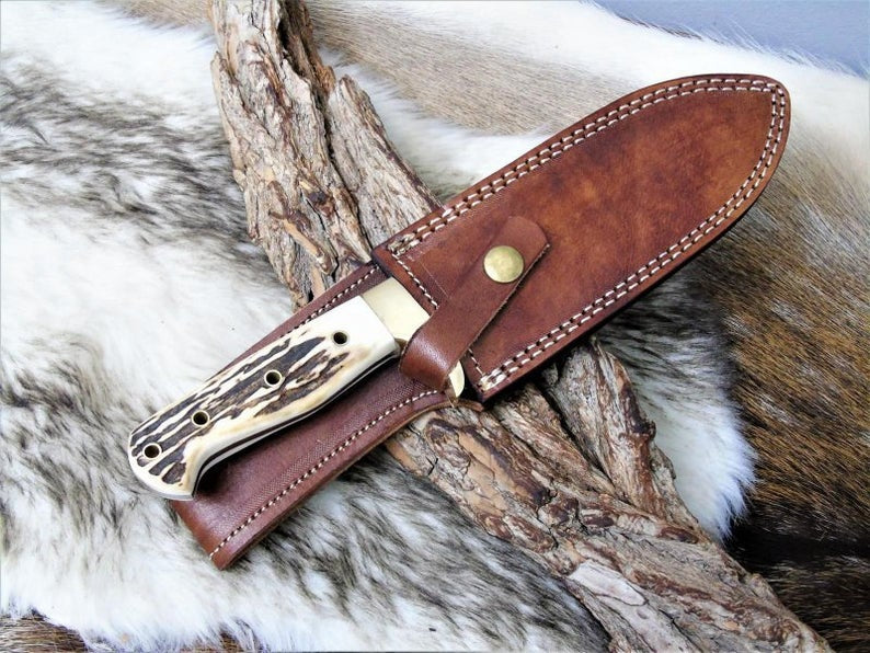 Custom handmade Damascus steel hunting knife with stag horn handle and leather sheath by Knives Gear Garage.