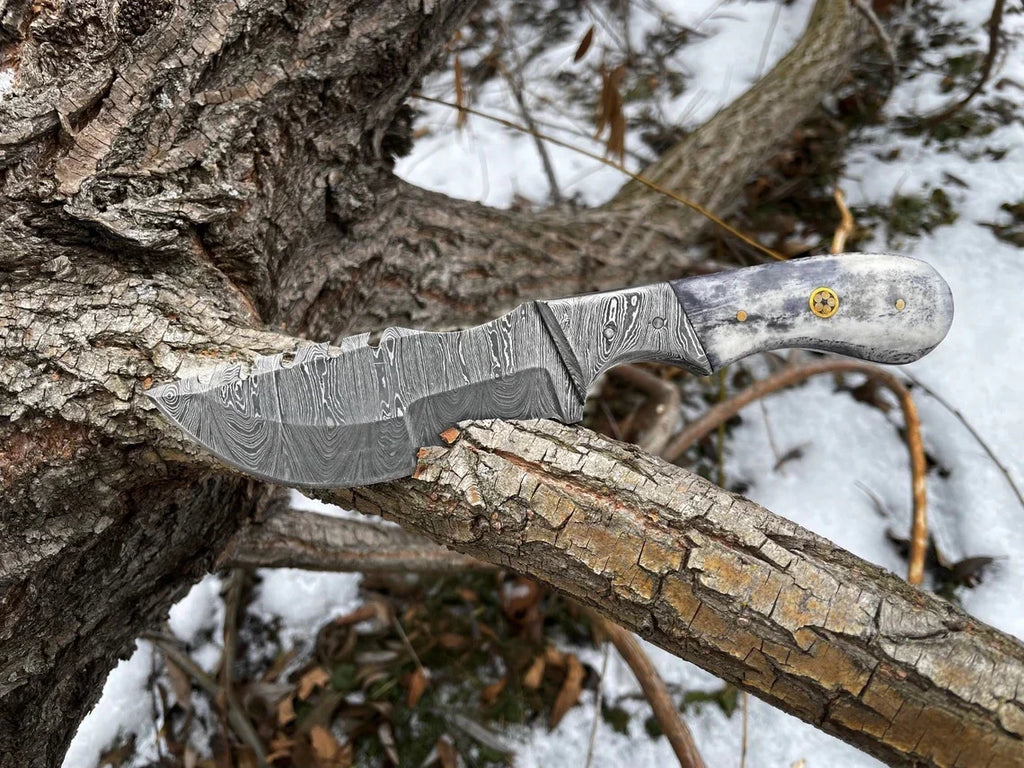Custom handmade Damascus steel tracker knife by Knives Gear Garage, showing the detailed patterned blade and sturdy handle.