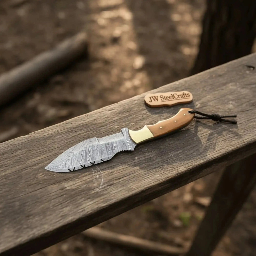 Handmade JW SteelCrafts Canyon Tracker Survival Knife with Damascus steel blade and ivory handle, designed for outdoor and survival use.