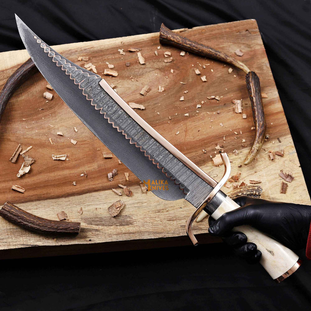 Copper Damascus Alamo Musso Bowie Knife by Malika Knives, featuring a sleek blade and wooden handle in a detailed in-hand view.