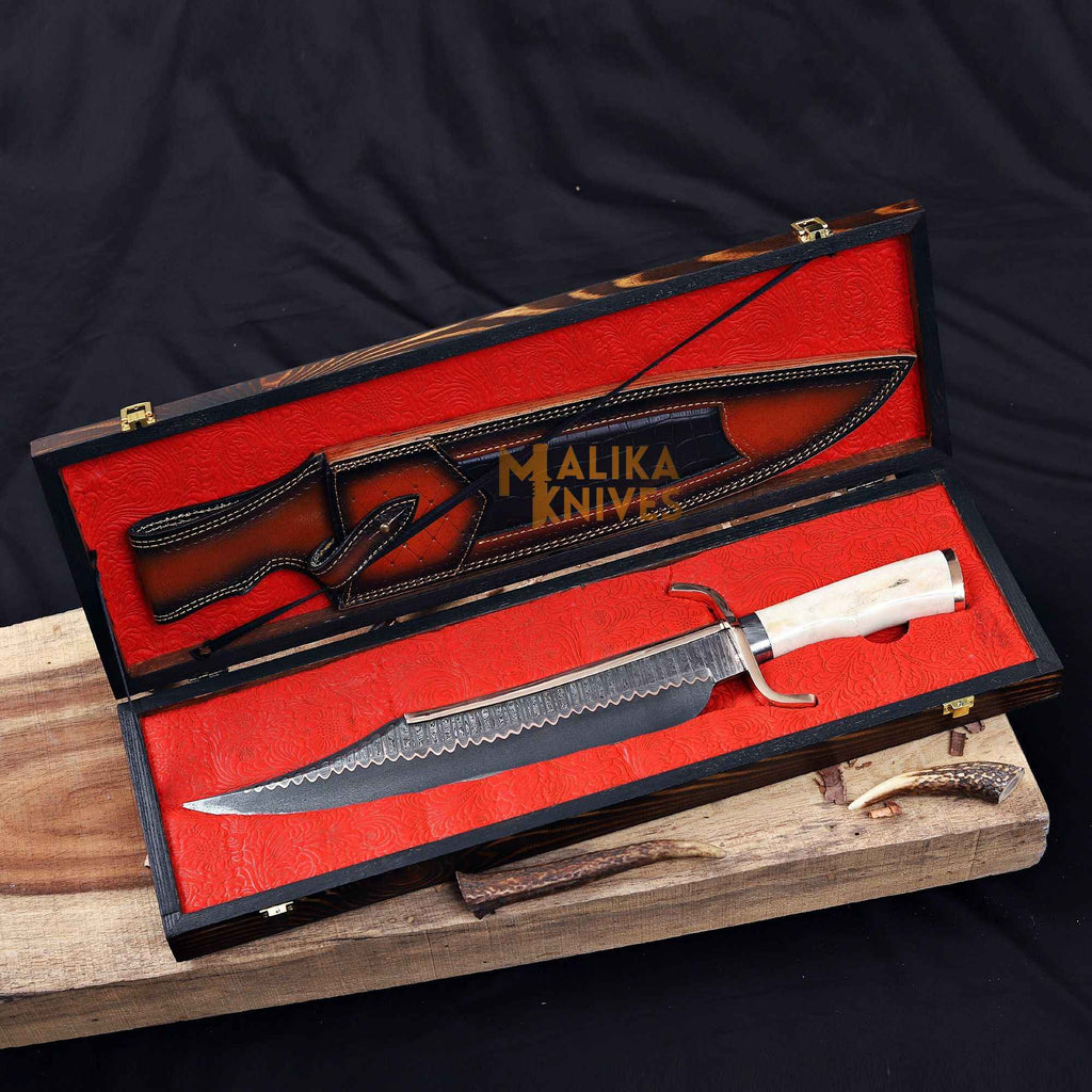 Copper Damascus Alamo Musso Bowie Knife by MALIKA KNIVES displayed in a wooden box, featuring a detailed Jim Bowie-style blade.