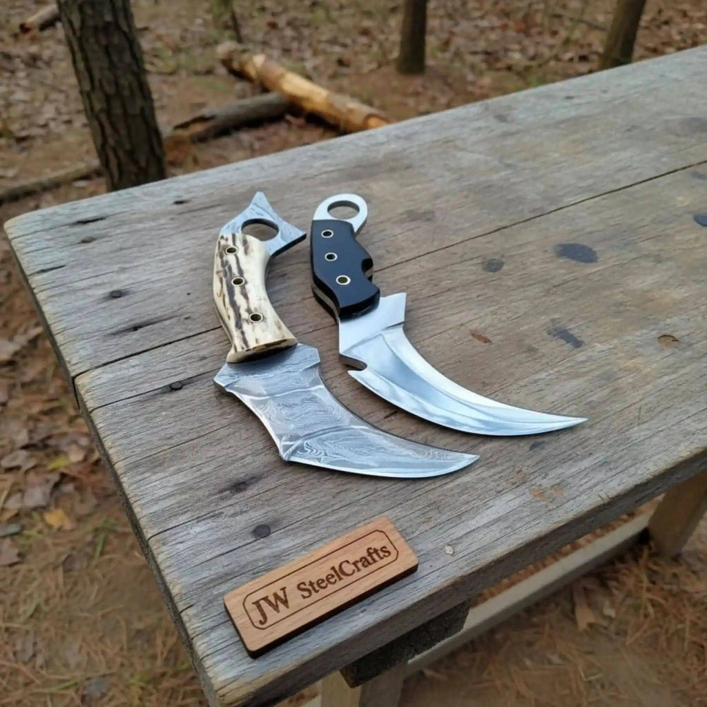 Pair of Damascus steel Karambit knives with stag horn and wood handles, 9-inch blades, crafted by JW SteelCrafts.
