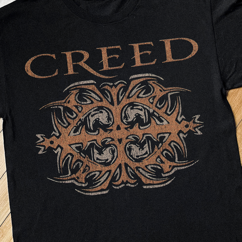 Close-up of the black Creed vintage T-shirt by Parallel, showing fabric texture and detailed design on the front.