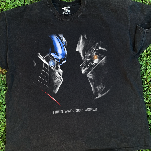 Vintage washed black Transformers T-shirt by Parallel featuring 'Their War. Our World.' design on the front.