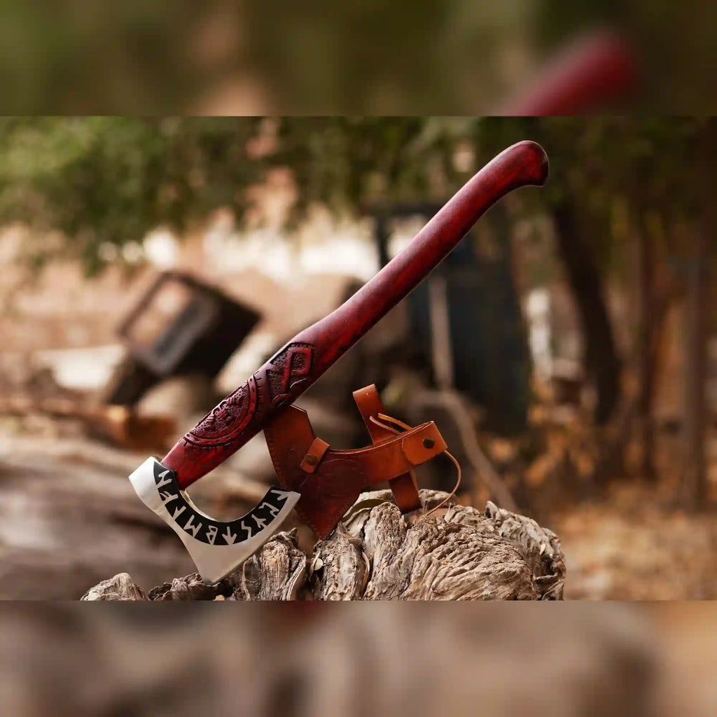 Runic Viking Axe by MALIKA KNIVES with hand-forged 1075 steel bearded head and long ash wood handle, shown with leather sheath.