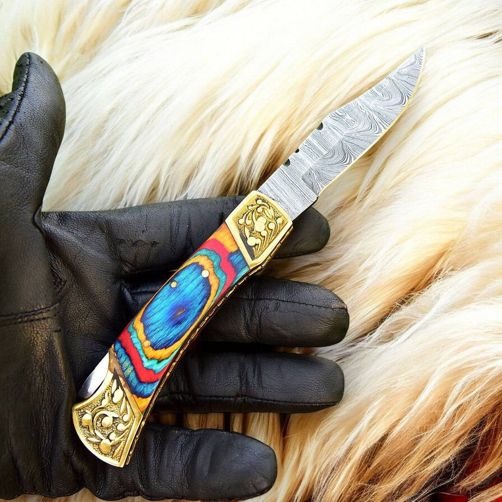 Custom handmade Damascus pocket knife with multi-color wood handle, featuring intricate steel blade craftsmanship.