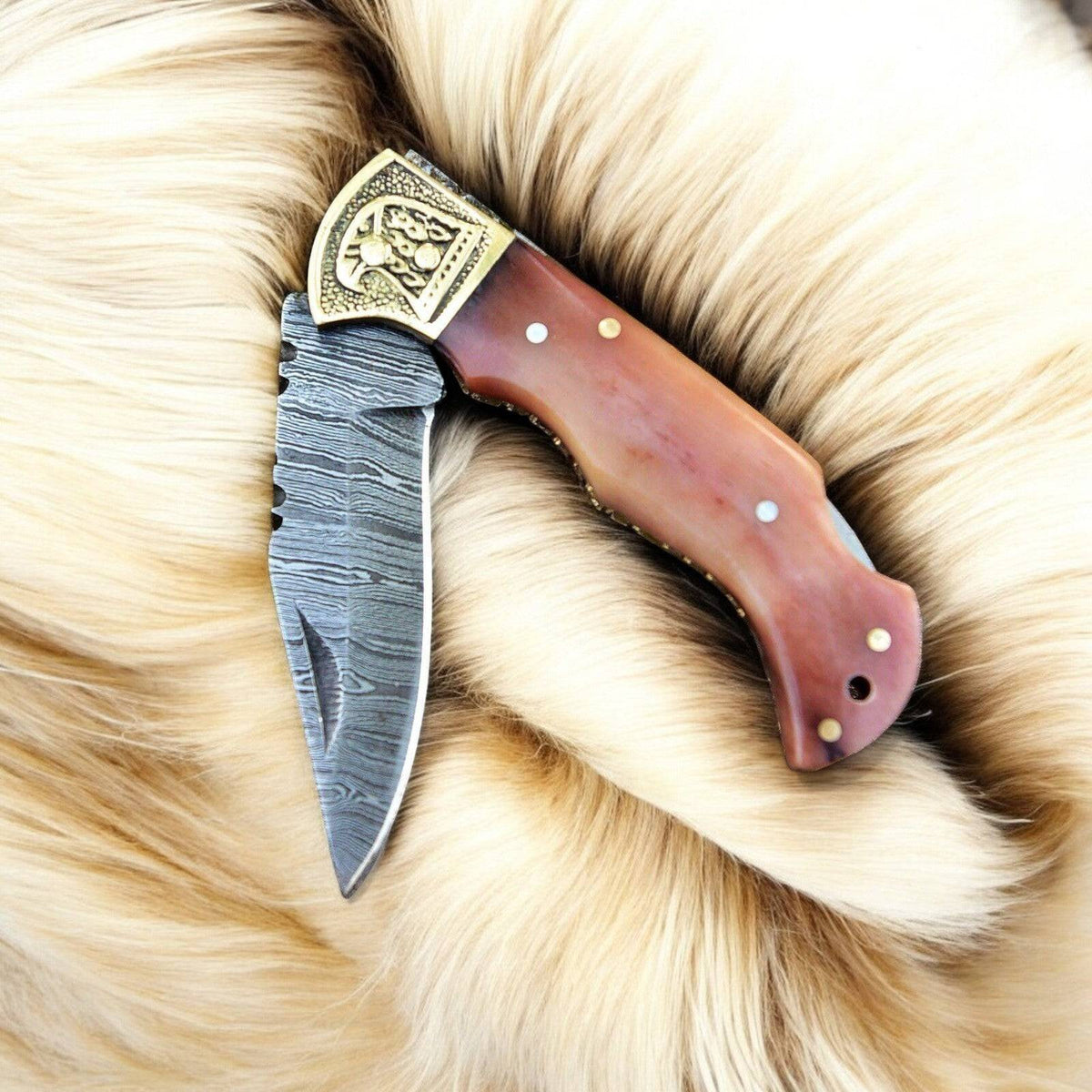 Custom handmade Damascus steel pocket clip knife with a 3-inch blade, featuring a textured handle and sleek design.