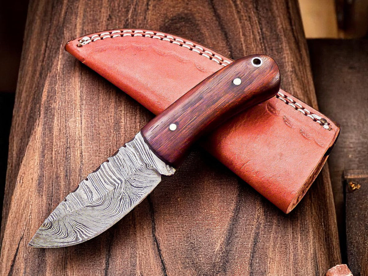 Custom handmade Damascus skinning knife with 6.25-inch blade, featuring a patterned Damascus steel blade and ergonomic handle.
