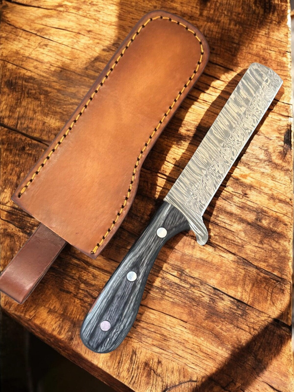 Custom handmade bull cutter knife with an 8-inch Damascus steel blade, featuring intricate patterns and a wooden handle.