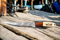 Custom handmade Damascus fillet knife with a 13-inch blade, featuring a bone and wood handle.