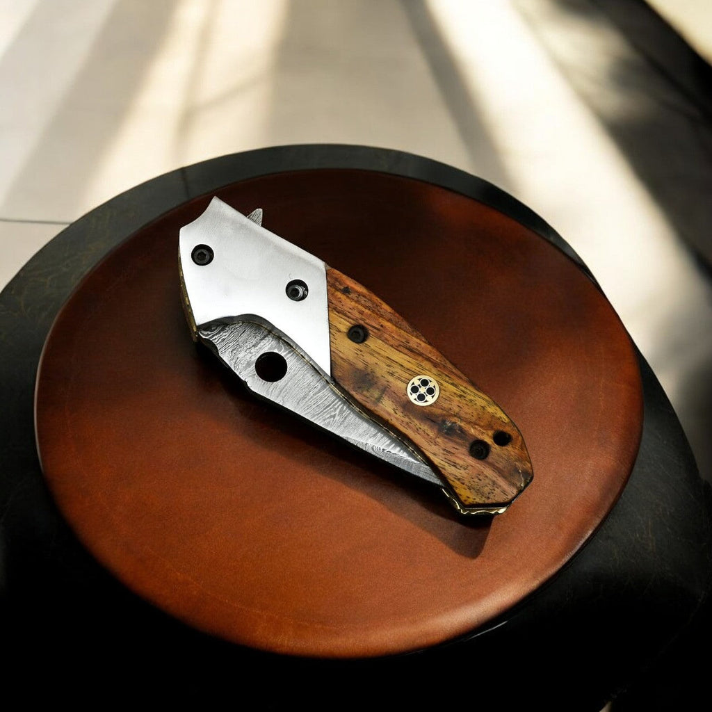 Exotic wood Damascus pocket knife from Damascus Knife Store with a sharp, handcrafted blade and a polished wooden handle.