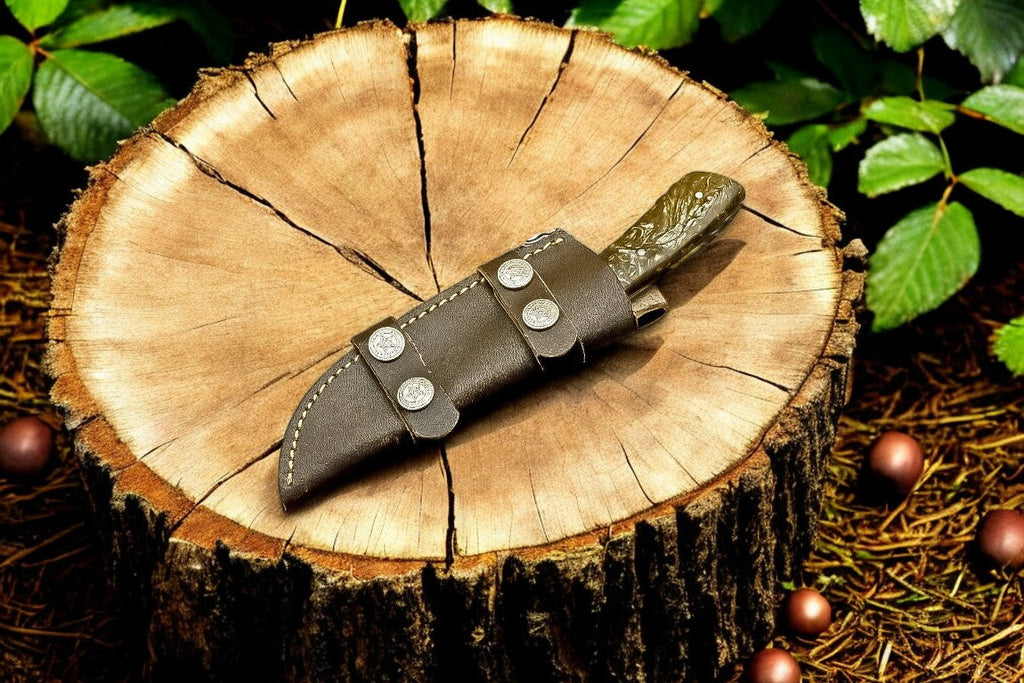 Handmade Damascus hunting knife with an exotic wood handle and intricate blade design, showcasing craftsmanship and natural wood grain.