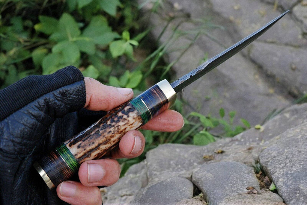 Handmade Damascus steel hunting knife with a detailed handle and custom blade, displayed on a neutral background.