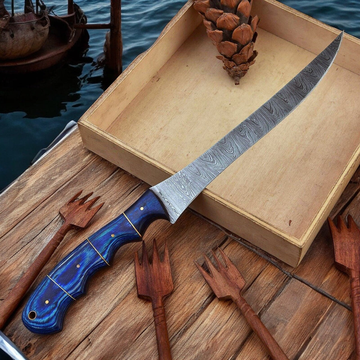 Custom handmade Damascus fillet knife with a 12-inch blade and exotic wood handle, showcasing craftsmanship and detailed blade pattern.