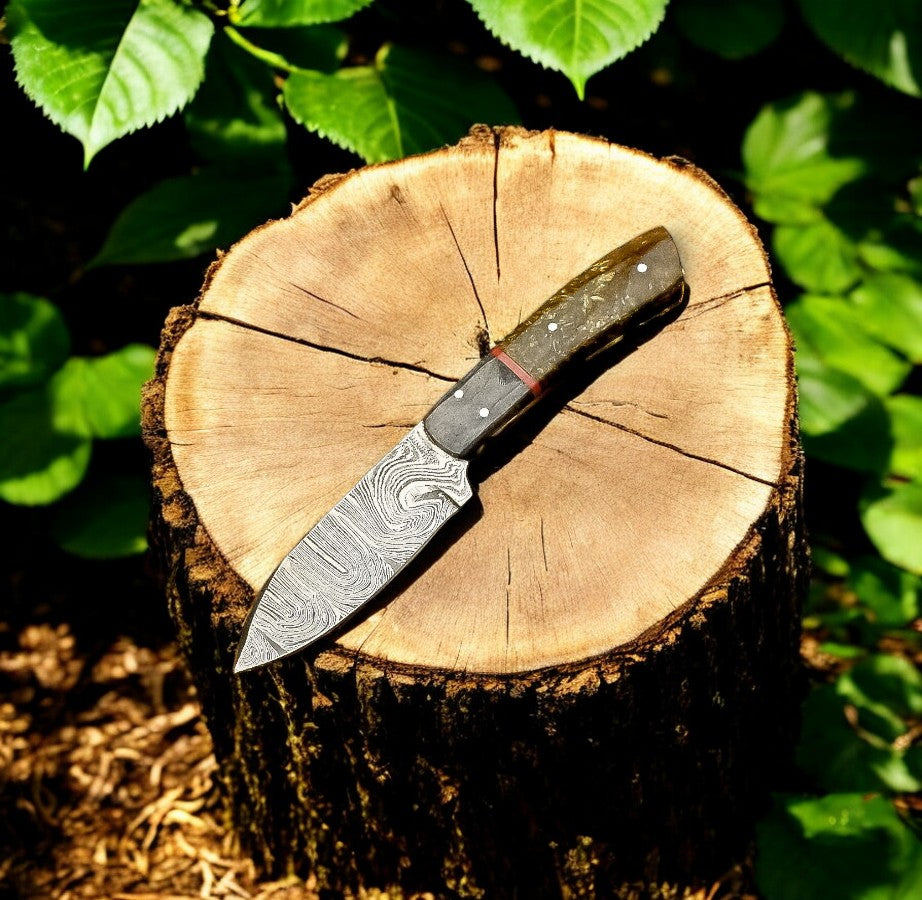 Handmade Damascus hunting knife with an exotic wood handle, featuring a sharp blade and detailed craftsmanship.
