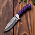 Handmade Damascus Steel hunting knife with an 8-inch blade and leather sheath, displayed on a wooden surface.