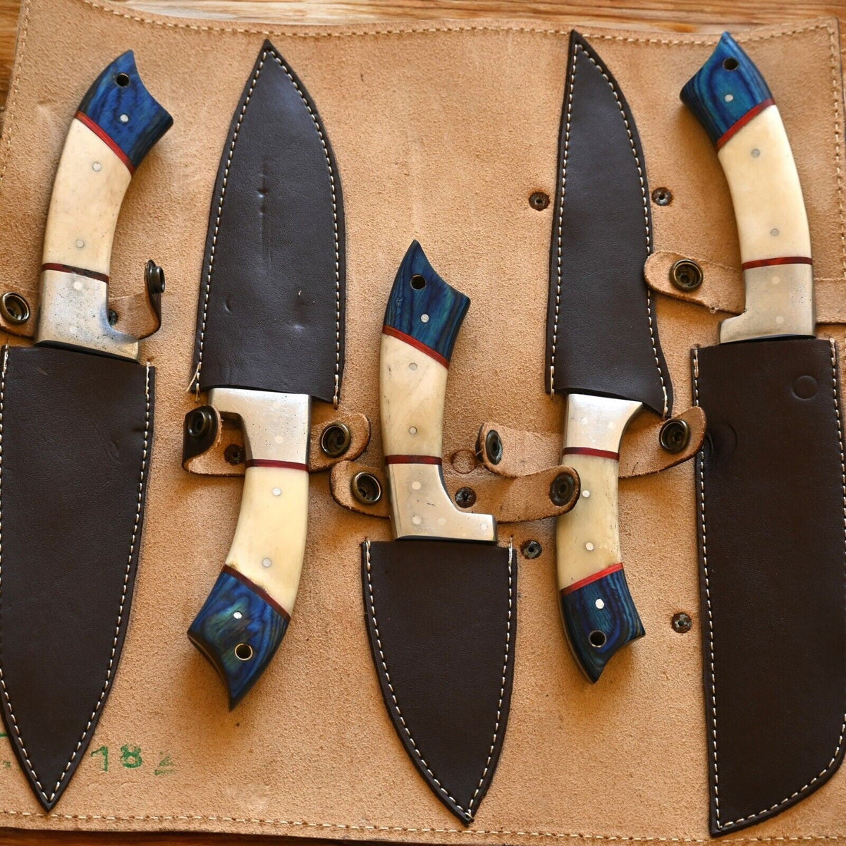 Handmade Damascus kitchen knives set with exotic wood and bone handles, showcasing sharp blades and intricate craftsmanship.