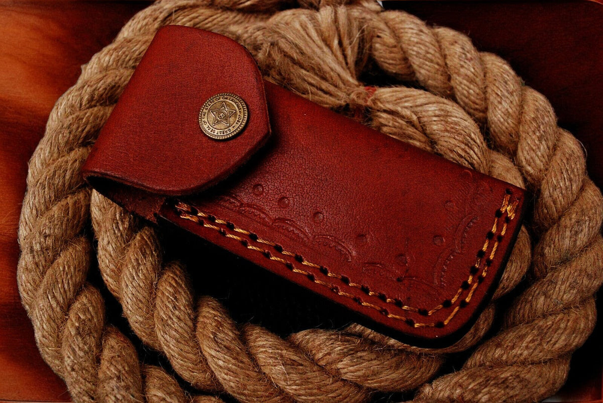 Custom handmade Damascus pocket knife with blue exotic wood handle, featuring intricate Damascus steel blade design.