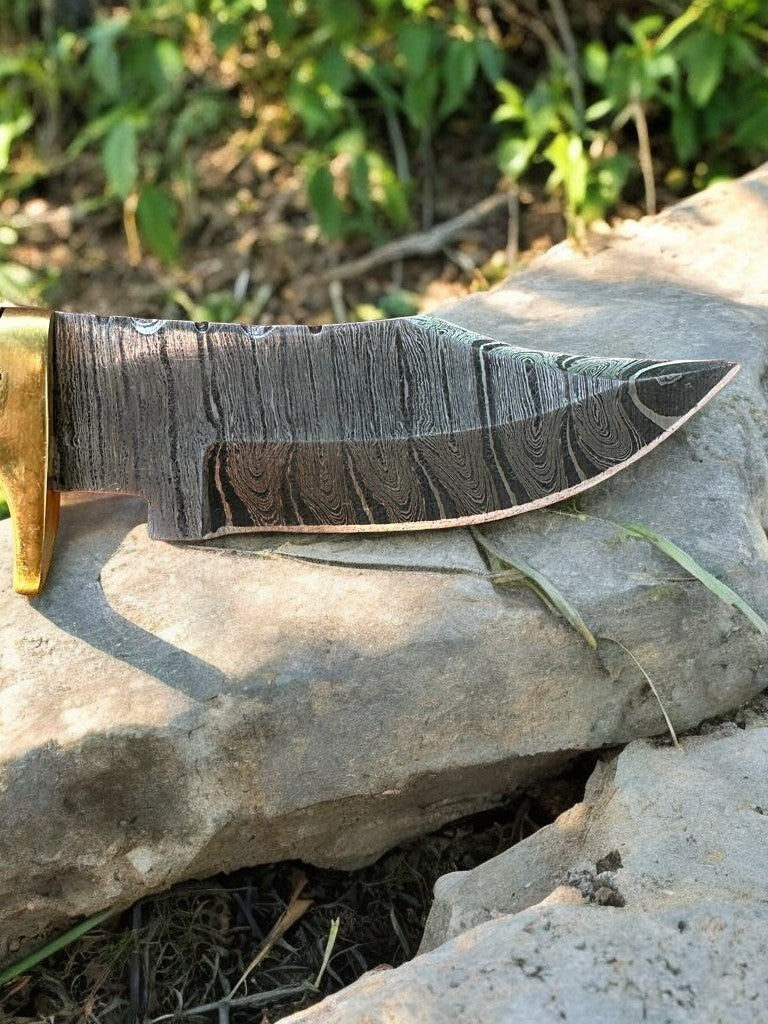 Handmade Damascus hunting knife with epoxy resin handle and detailed blade, displayed on a neutral background.