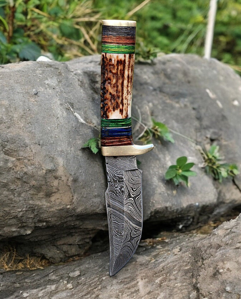 Custom handmade hunting knife with Damascus steel blade, featuring a leather handle and detailed craftsmanship.