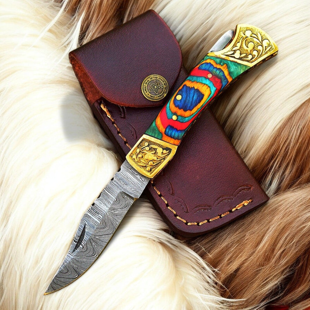 Custom handmade Damascus pocket knife with multi-color wood handle, showcasing intricate blade design and polished wooden grip.