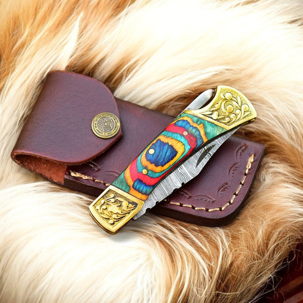 Custom handmade Damascus pocket knife with a multi-color wood handle, showcasing polished blade and detailed craftsmanship.