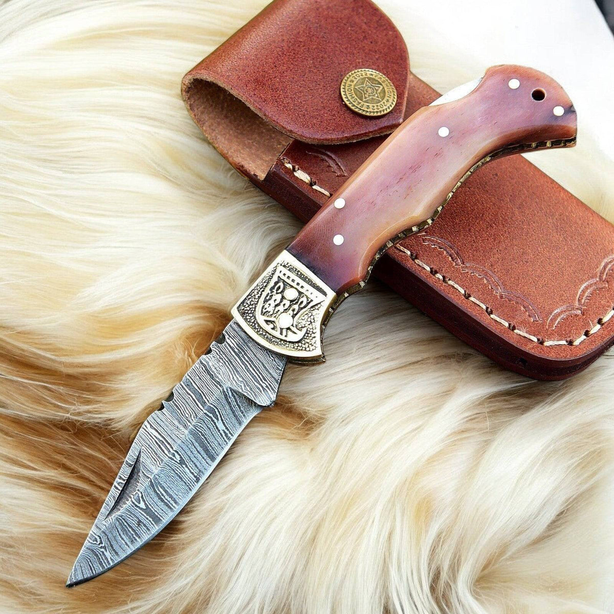 Custom handmade Damascus steel pocket clip knife with a 3-inch blade, featuring a detailed Damascus Knife Store design.