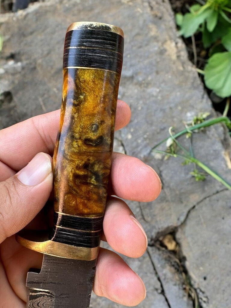 Handmade Damascus hunting knife with epoxy resin handle, featuring a Damascus Knife Store logo on the blade.
