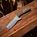 Custom handmade bull cutter knife with high carbon steel blade from Damascus Knife Store, featuring a detailed leather handle.
