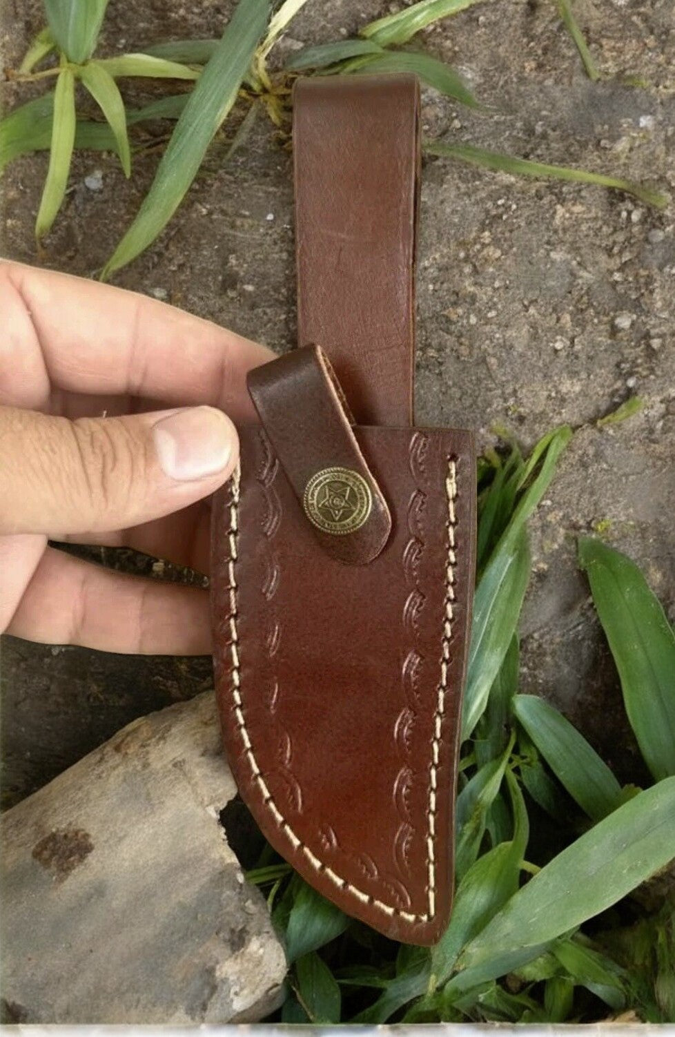 Handmade Damascus hunting knife with epoxy resin handle, featuring intricate blade pattern and ergonomic grip for outdoor use.