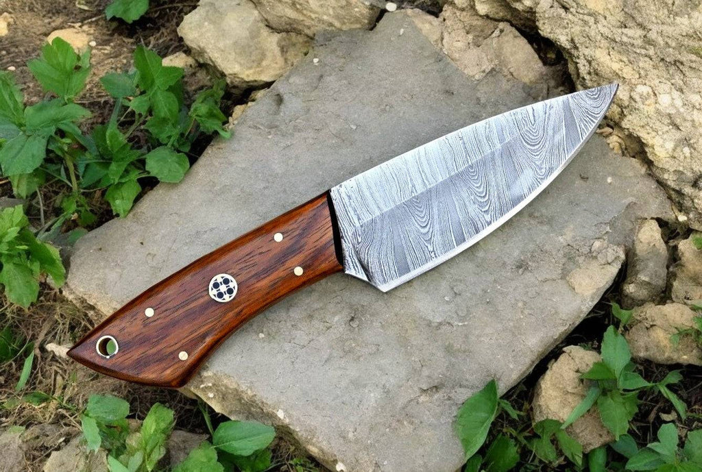 Handmade Damascus hunting knife with a polished rosewood handle and a sharp steel blade, displayed on a neutral background.