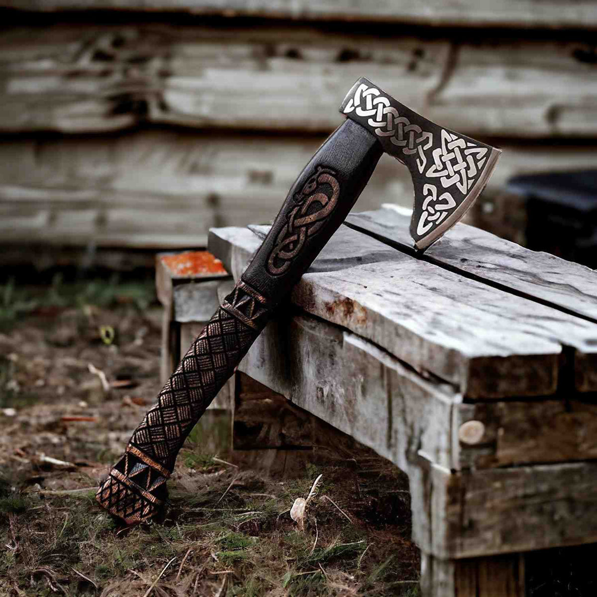 Hand-forged Viking axe with Celtic knotwork design, bearded blade, and carved wooden handle from MALIKA KNIVES.
