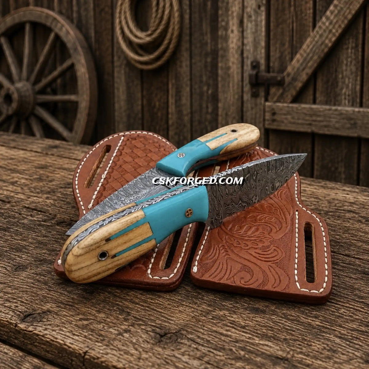 Set of cowboy skinning knives with Damascus steel blades and blue Maverick handles, shown in a cross-draw sheath.